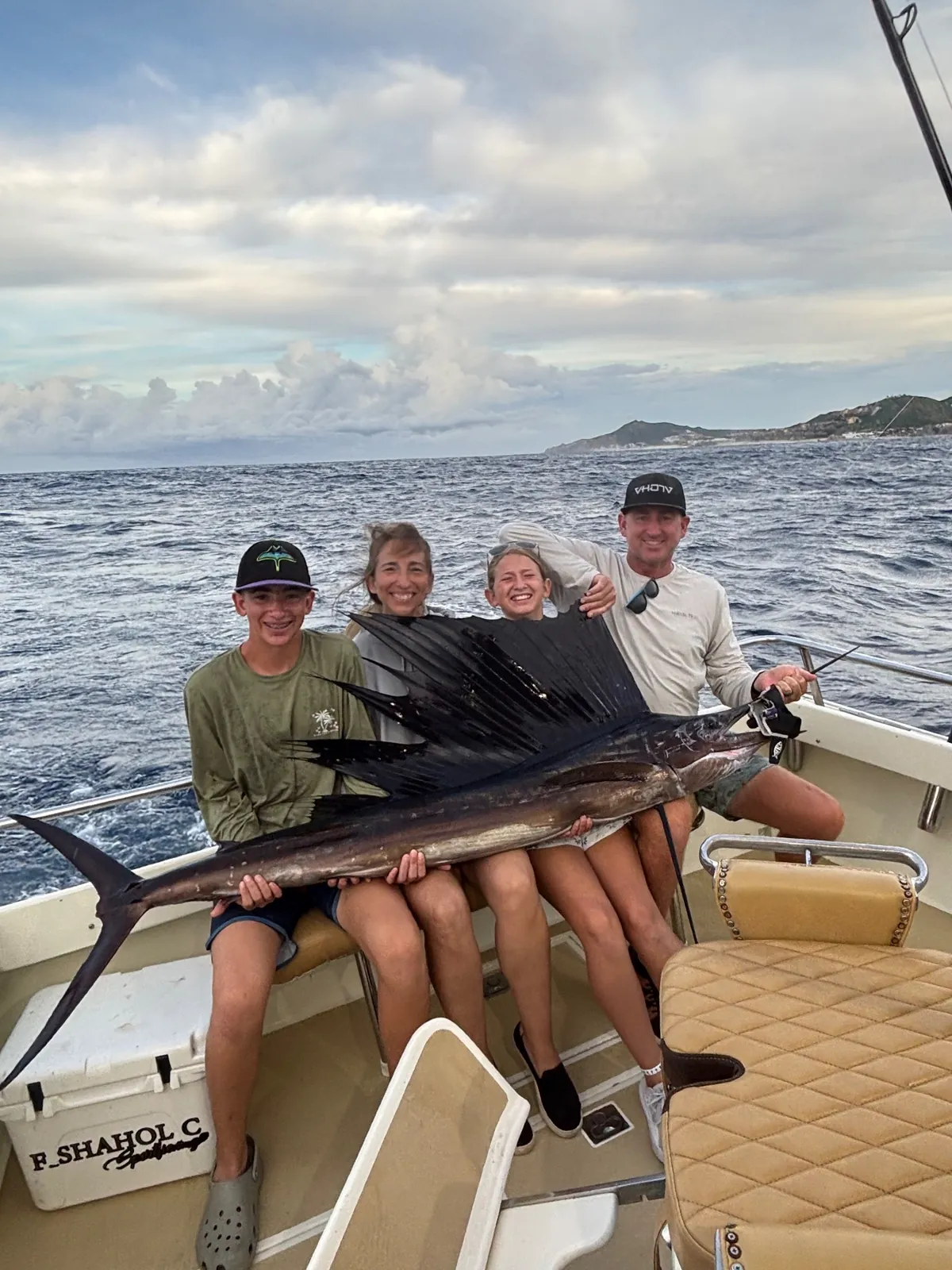 Family with a sailfish aboard Fishaholic off Los Cabos