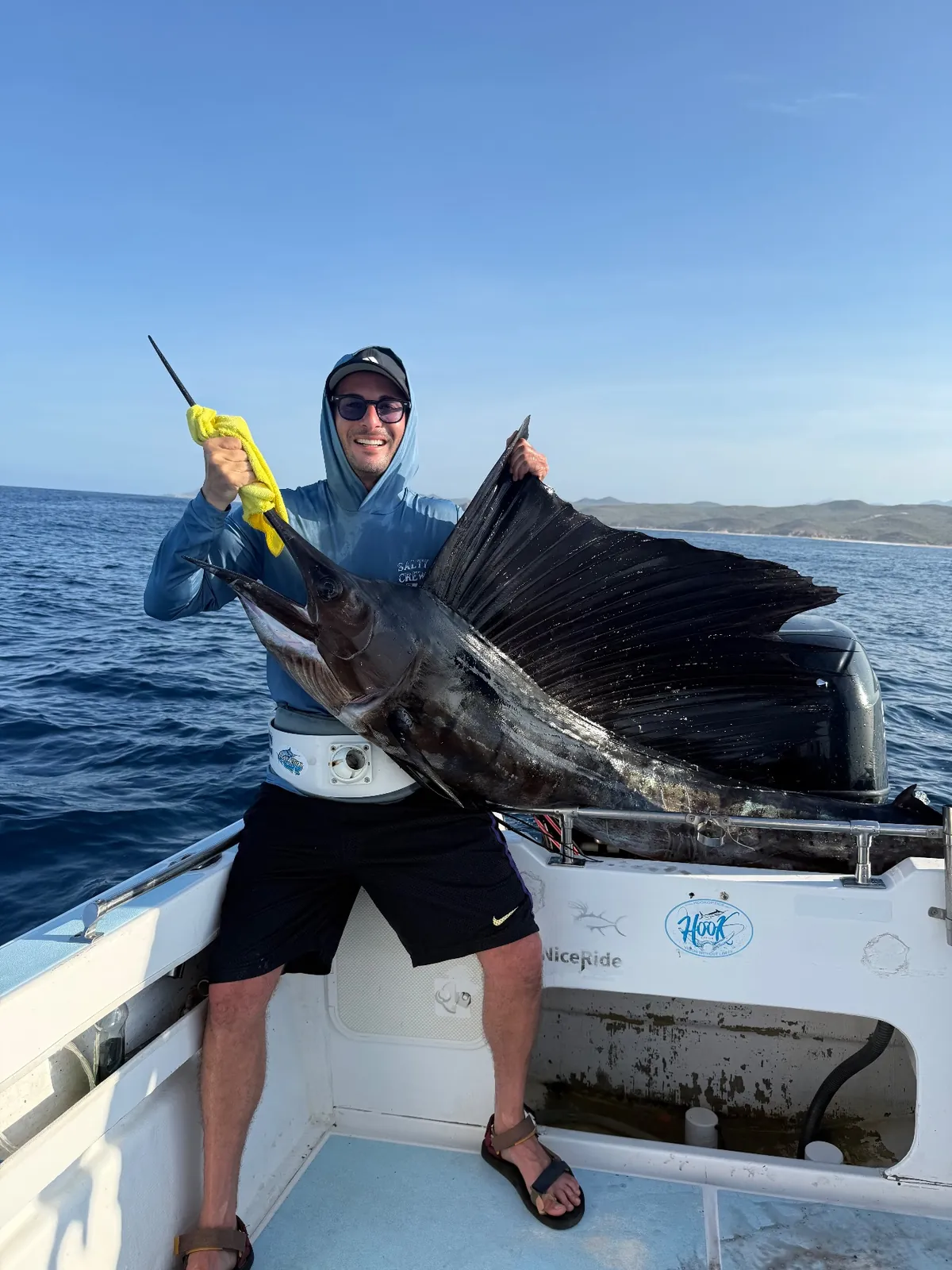 Angler with a sailfish aboard a Playita charter off Los Cabos
