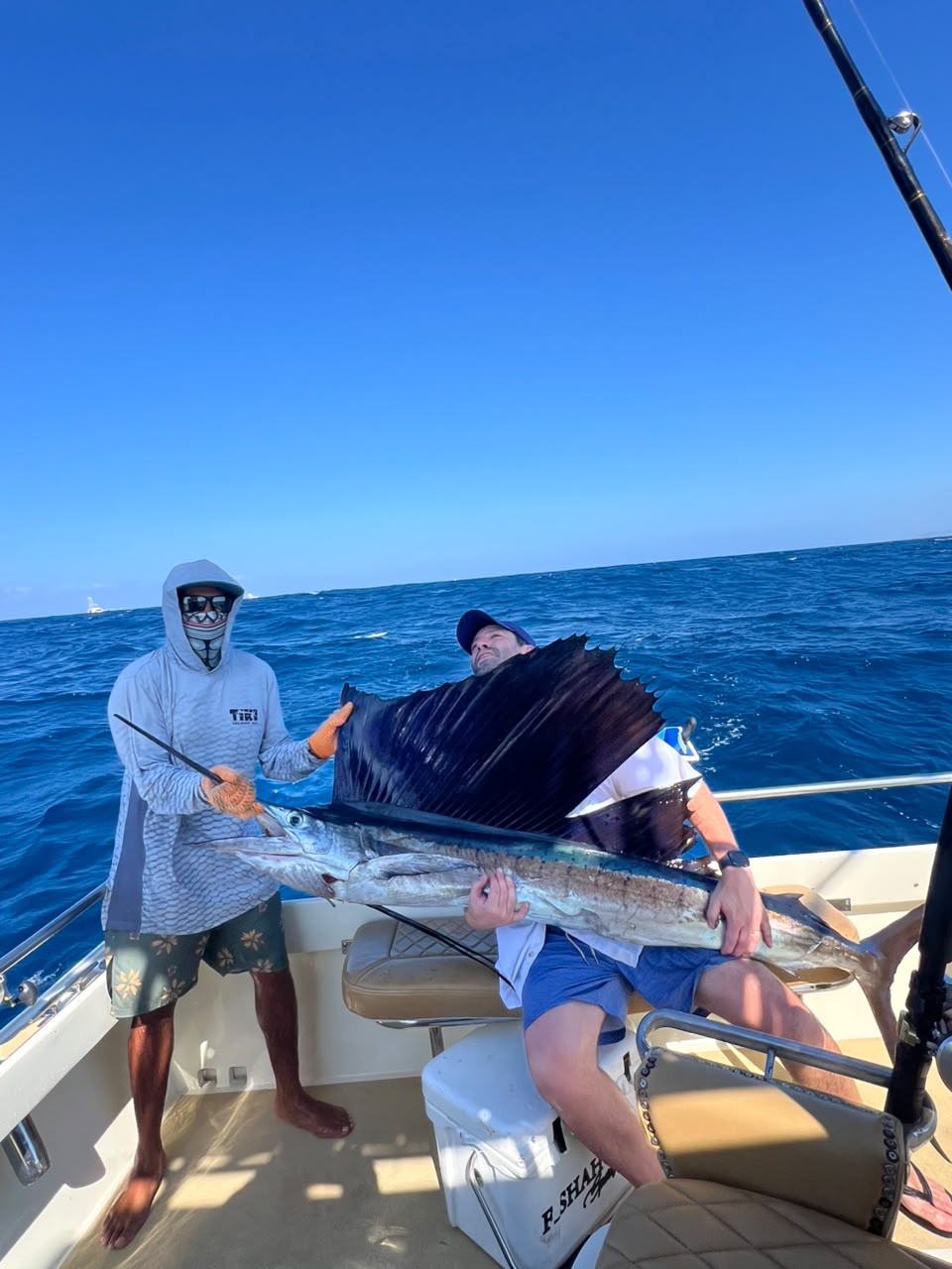 Anglers with a sailfish aboard a sportfishing boat off Los Cabos