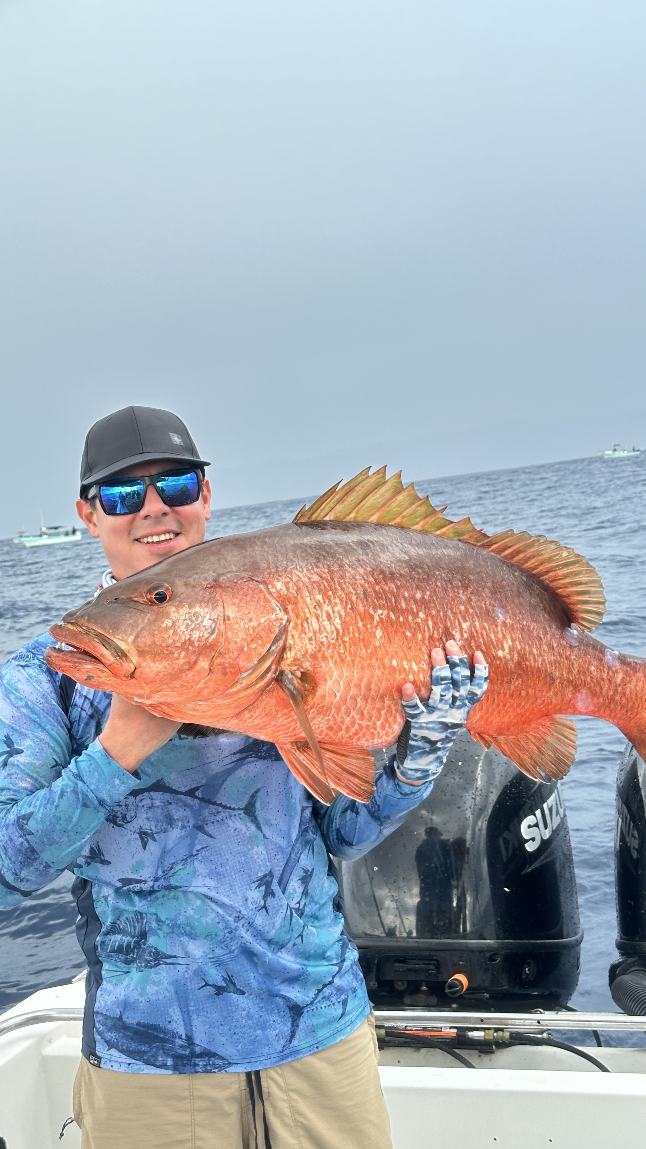 Angler holding a large snapper